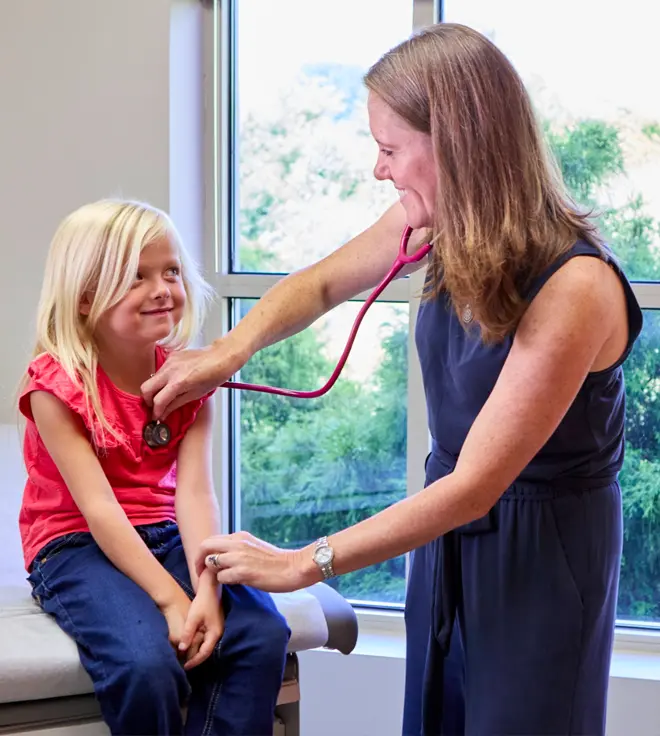 Pediatrician with child patient